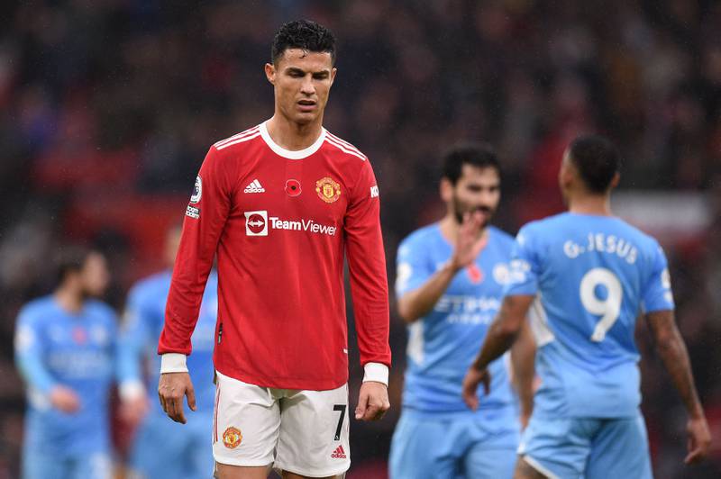 Manchester United striker Cristiano Ronaldo during the match as Manchester City players celebrate in the background. AFP