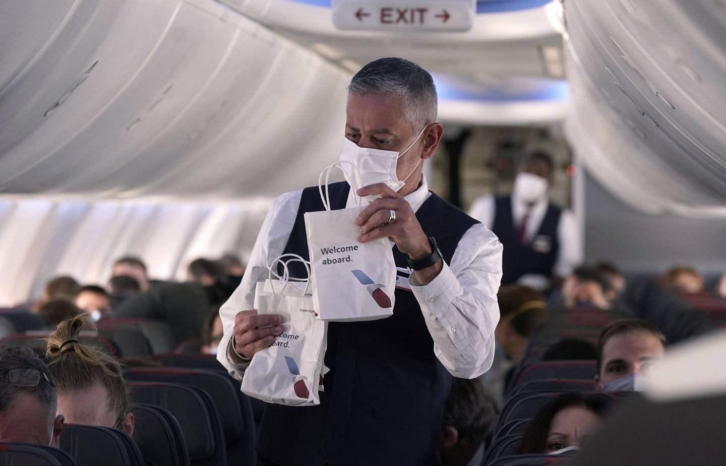 An American Airlines flight attendant hands out snack bags during a flight from Dallas Fort Worth airport in Grapevine, Texas. AP Photo 