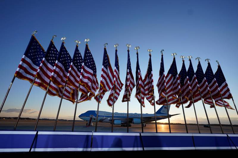 Air Force One is prepared for President Donald Trump as flags fly on a stage at Andrews Air Force Base. AP Photo
