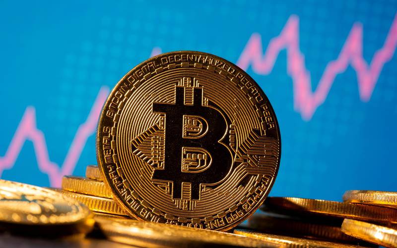 FILE PHOTO: A representation of virtual currency Bitcoin is seen in front of a stock graph in this illustration taken November 19, 2020. REUTERS/Dado Ruvic/Illustration/File Photo