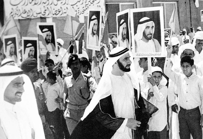 Sheikh Zayed bin Sultan al-Nahyan walks past supporters in the emirate of Fujairah during his in January 1972.  WAM