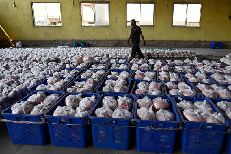 A Sri Lanka’s Civil Defence Force personnel walks among packages of dry rations of food and commodities to be distributed, during a government-imposed nationwide lockdown as a preventive measure against the COVID-19 coronavirus, at a warehouse near Colombo.  AFP