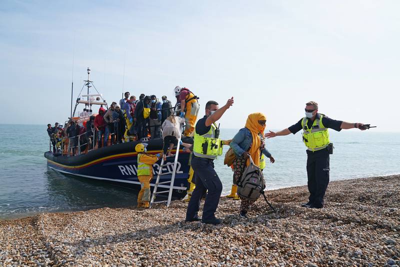 A group of people thought to be migrants brought ashore from a lifeboat at Dungeness in Kent as the UK dealt with a surge in Channel crossings. PA