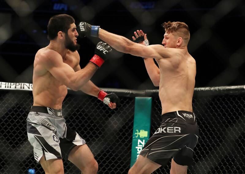Dan Hooker, right, throws a punch at Islam Makhachev. Chris Whiteoak / The National