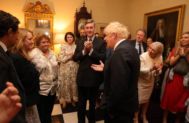 Staff members rally round Mr Johnson after his speech.