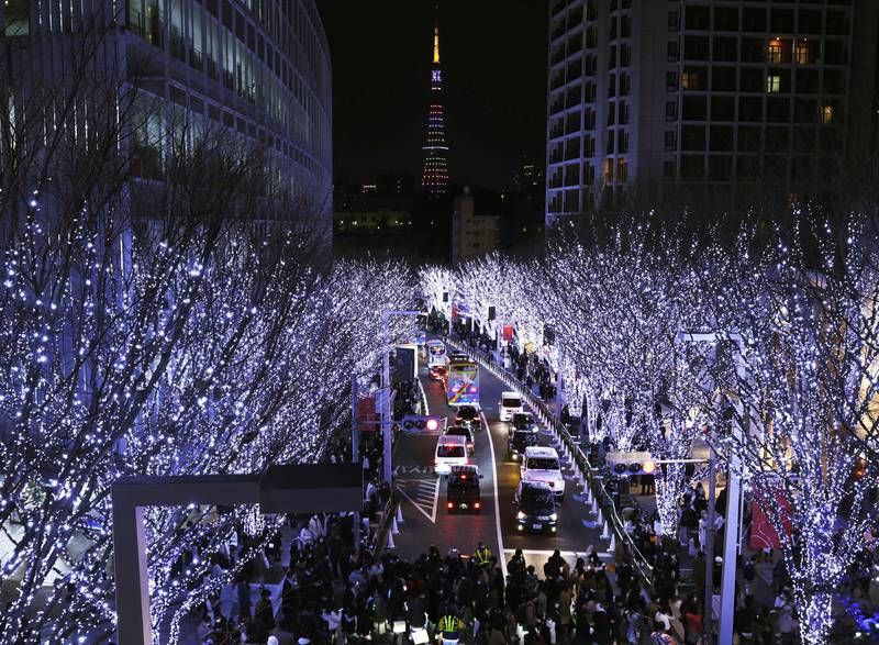 People walk through an illuminated street in Tokyo on Christmas Eve. AP