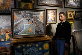Artist Zhao Xiaoyong with his paintings in Dafen Village, Guangdong province, China. AFP