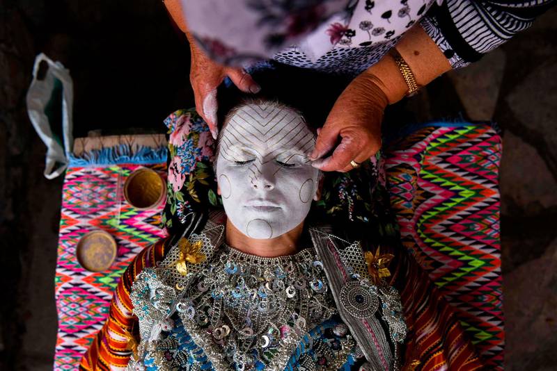 Buqaj receives a traditional face painting. AFP