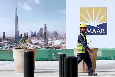An Emaar Properties sign is seen against the backdrop of the Burj Khalifa, which the company developed. Satish Kumar / The National