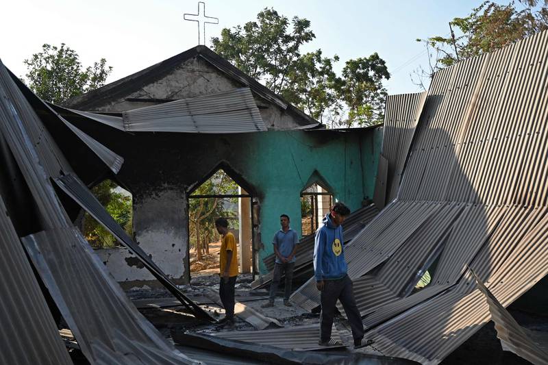 Villagers inspect the debris of a ransacked church that was set on fire in the Senapati district of Manipur. AFP