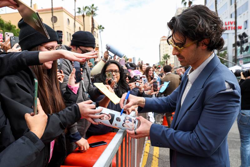 Joe Jonas signs autographs for fans lining Hollywood Boulevard. Reuters