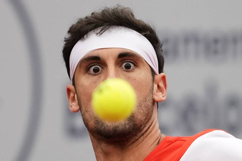 Spanish tennis player Carlos Taberner returns the ball against Canadian Felix Auger-Aliassime during their tennis match at the Barcelona Open tennis tournament.  EPA
