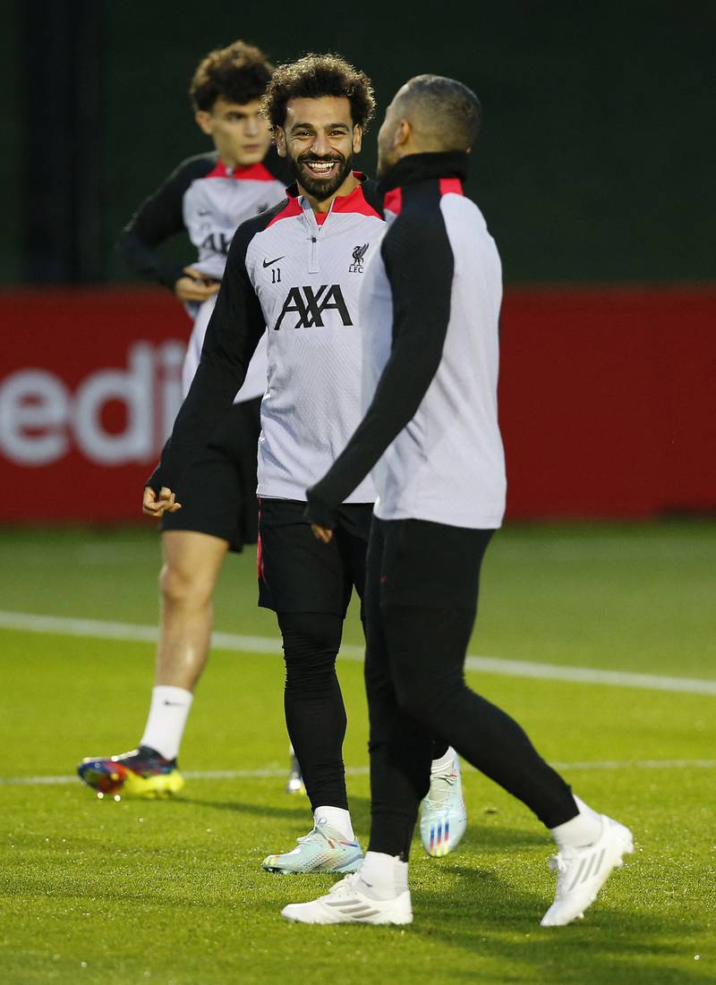 Liverpool's Mohamed Salah and Thiago Alcantara share a joke at training. Reuters