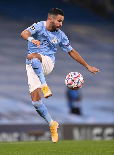 MANCHESTER, ENGLAND - OCTOBER 21: Riyad Mahrez of Manchester City jumps to control the ball during the UEFA Champions League Group C stage match between Manchester City and FC Porto at Etihad Stadium on October 21, 2020 in Manchester, England. Sporting stadiums around the UK remain under strict restrictions due to the Coronavirus Pandemic as Government social distancing laws prohibit fans inside venues resulting in games being played behind closed doors. (Photo by Laurence Griffiths/Getty Images)