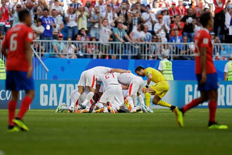 Serbian players celebrate their first goal during the group E match. Natacha Pisarenko / AP Photo