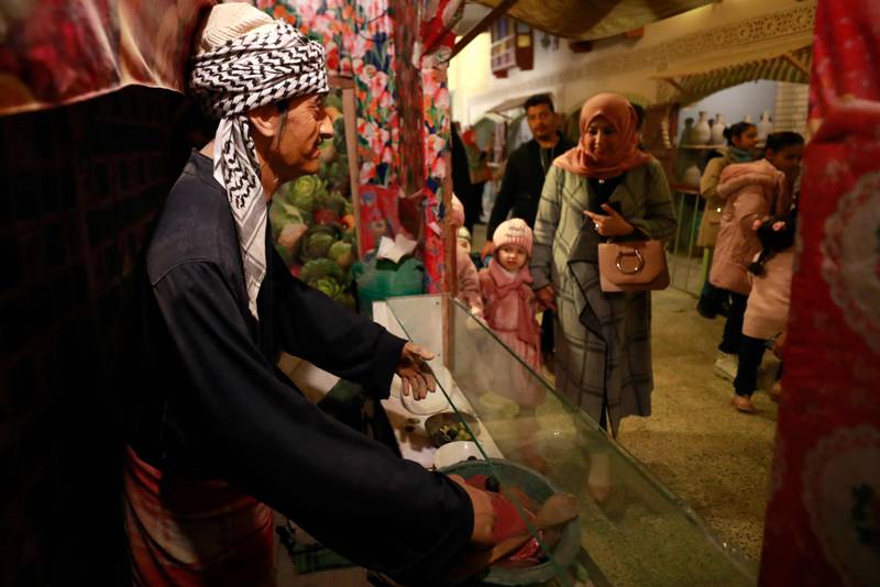 Iraqis visit the Baghdadi Museum, which features scenes of Baghdad life, folk crafts and local customs across different periods, near the Tigris River in capital Baghdad on December 30, 2022.  (Photo by AHMAD AL-RUBAYE  /  AFP)
