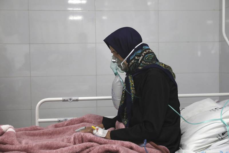 A Covid-19 patient breathes with an oxygen mask in Amir Al Momenin Hospital in the city of Qom. The Iranian leadership has been criticised for its handling of the pandemic. AP