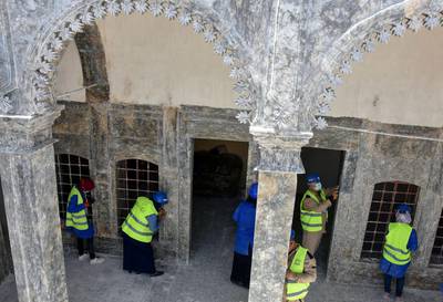 Unesco workers renovate heritage buildings with ornate arches in the Old City of Mosul. Much of the Old City was destroyed during the occupation by ISIS from 2014 and 2017, including fighting to retake the city. Reuters