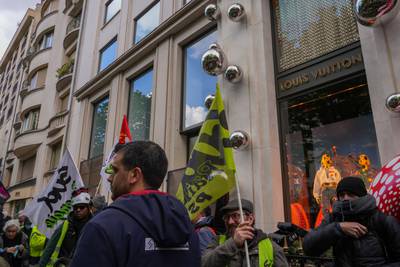 Protesters outside a Louis Vuitton luxury goods boutique. Bloomberg