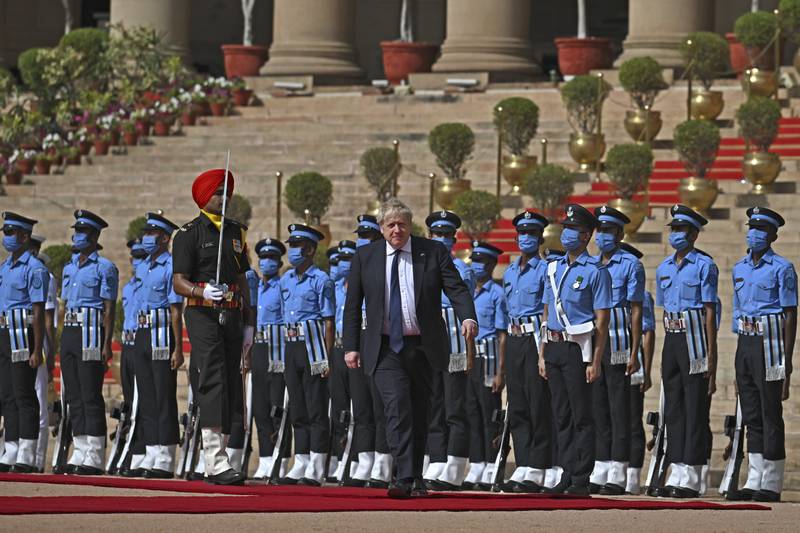 Boris Johnson inspects a guard of honour during a ceremonial reception at presidential palace Rashtrapati Bhavan in New Delhi. Getty Images