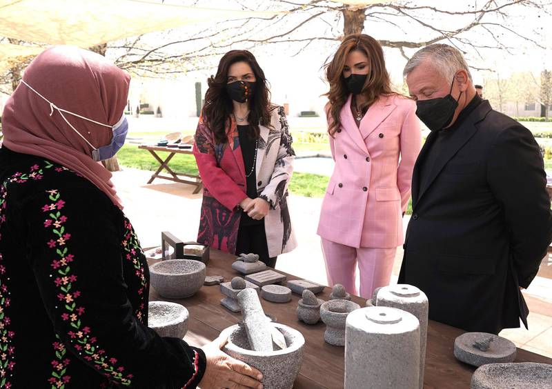 King Abdullah II, accompanied by Queen Rania Al Abdullah, views sample products from beneficiaries of the Productive Youth Initiative. Courtesy Royal Hashemite Court