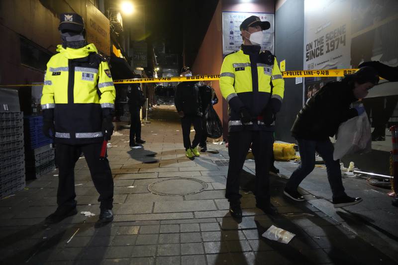 Police officers cordon off the site of the deadly crush in Itaewon. AP