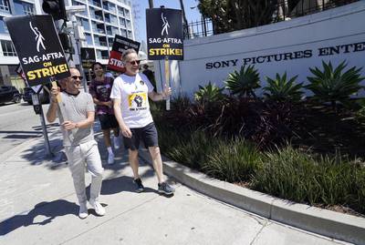Paul and Cranston walk the picket line outside Sony Pictures studios. AP