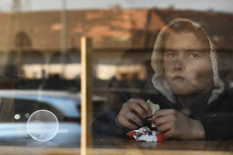 A young boy from Ukraine eats chocolate in a hostel in Budapest. AP