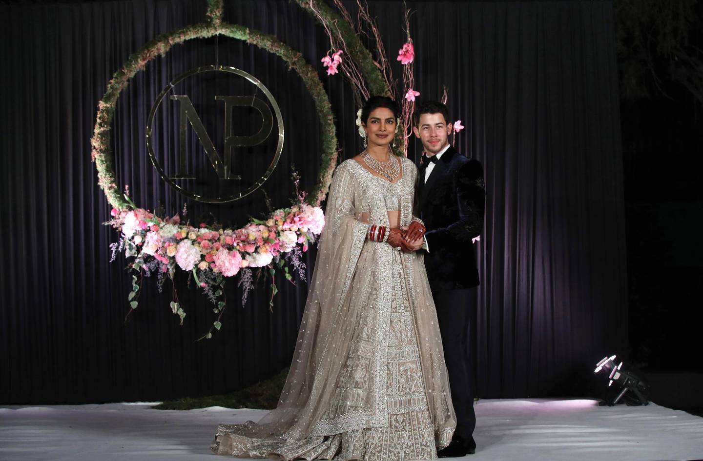 epa07208514 Newlyweds, Bollywood actress Priyanka Chopra (L) and US musician Nick Jonas (R) pose for photographs during a reception in New Delhi, India, 04 December 2018. According to media reports, the couple hosted wedding celebrations in Jodphur on 01 and 02 December.  EPA-EFE/RAJAT GUPTA