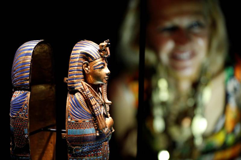 A woman looks at miniature canopic coffin during the media preview of "Tutankhamun: Treasures of the Golden Pharaoh" exhibition set to open at the Saatchi Gallery in London, Britain November 1, 2019. Reuters