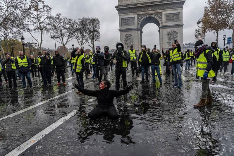 Yellow vest protesters clash with riot police near the Arc de Triomphe in December 2018.