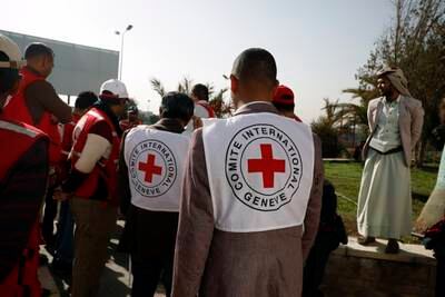 Members of the International Committee of the Red Cross wait to receive exchanged detainees loyal to the Houthis at Sanaa Airport. EPA