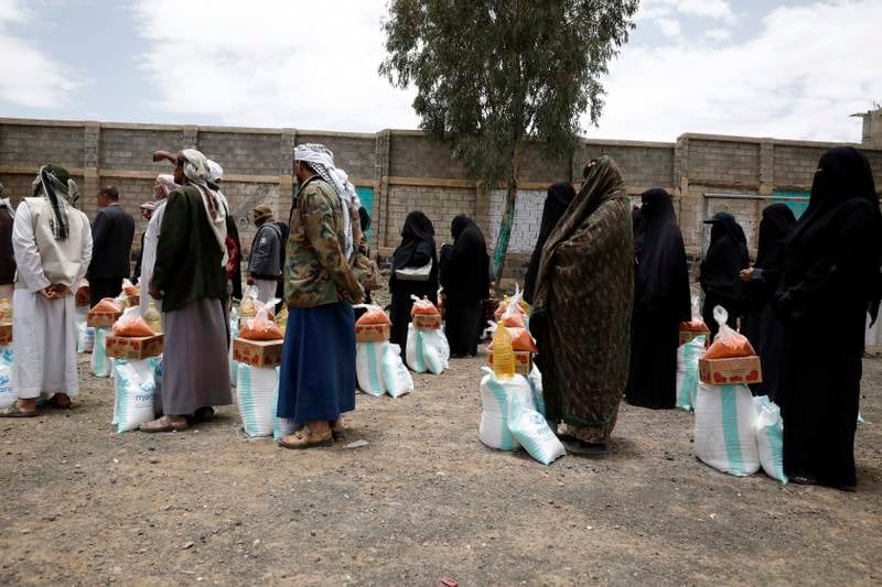 Yemenis receive food aid provided by a local relief agency in Sanaa. EPA