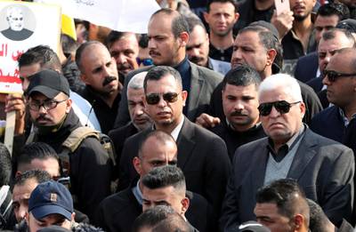 Head of the Popular Mobilization forces Faleh al-Fayyad (R) attends the funeral of the Iranian Major-General Qassem Soleimani, head of the elite Quds Force of the Revolutionary Guards, and the Iraqi militia commander Abu Mahdi al-Muhandis, who were killed in an air strike at Baghdad airport, in Baghdad. REUTERS