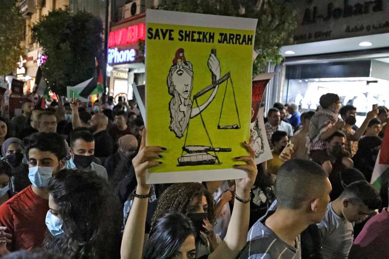 Palestinians protest in the occupied West Bank city of Ramallah, in solidarity with Palestinian families facing Israeli eviction orders in the Sheikh Jarrah neighbourhood of East Jerusalem. AFP