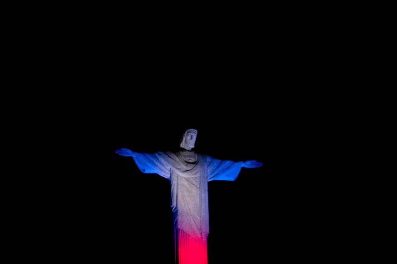 The statue of Christ The Redeemer bears the colours of Britain's flag in honour of the late queen, in Rio de Janeiro, Brazil. AFP