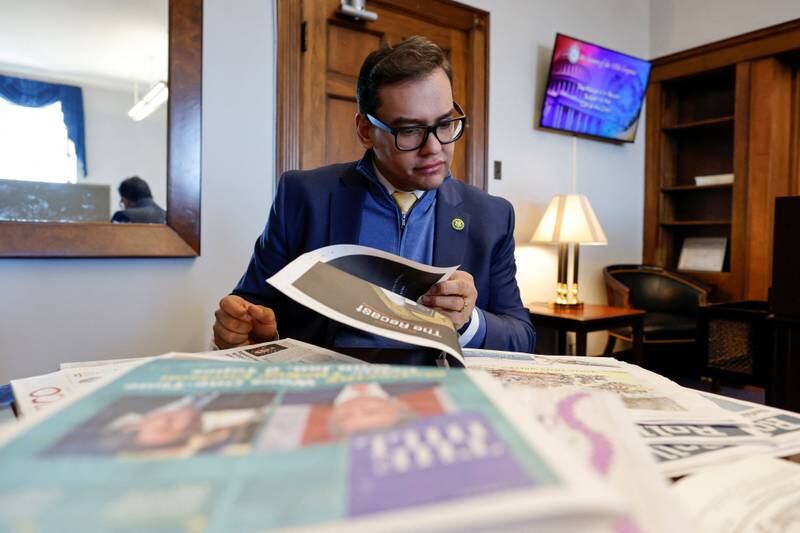 Santos checks the newspapers in his Capitol Hill office. Reuters