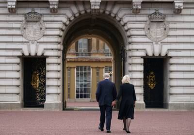 King Charles and Queen Camilla walk across the forecourt of Buckingham Palace, London, as he enters the palace for the first time as the new King in September 2022