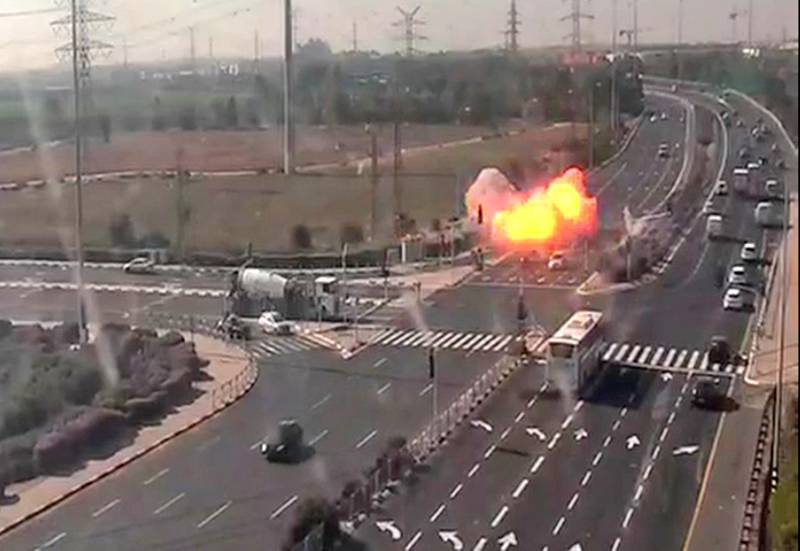 An image grab from footage taken from a CCTV camera belonging to the Israeli government company, the National Transport Infrastructure Company (Netivey Israel), shows the captured moment when a rocket fired from the Gaza Strip hit a highway narrowly missing several speeding vehicles near Israel's Gan Yavne. AFP PHOTO