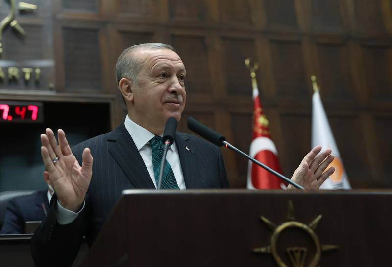 Turkish President Recep Tayyip Erdogan addresses his ruling party legislators, in Ankara, Turkey, Wednesday, Feb. 10.2021.  Erdogan on Wednesday ruled out discussing a federal system to reunify Cyprus, insisting that a two-state accord is the only solution for the ethnically-split island. (Turkish Presidency via AP, Pool)
