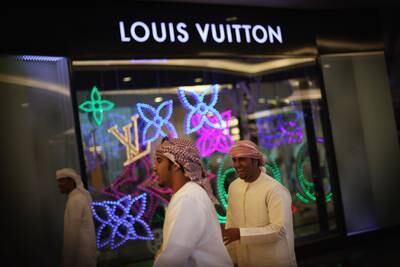 People walk past a Louis Vuitton shop inside Mall of the Emirates in Dubai in 2009