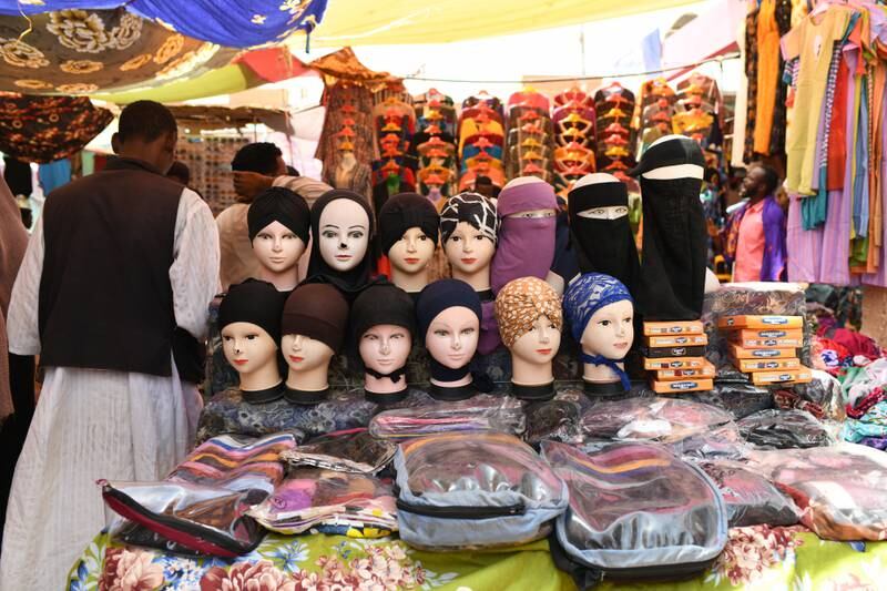 A vendor displays his selection of hats, scarves and glasses. EPA 