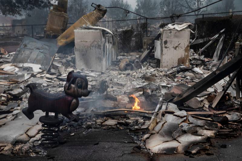 Smoke and small fires in a neighbourhood in Talent, Oregon after wildfires swept through the area. AP Photo