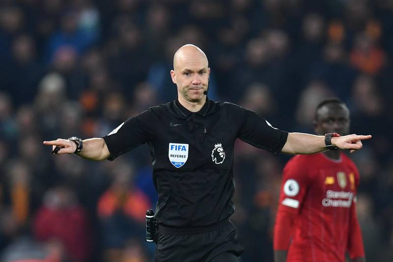 Referee Anthony Taylor gestures for VAR decision after Pedro Neto put the ball in the net for Wolves. AFP