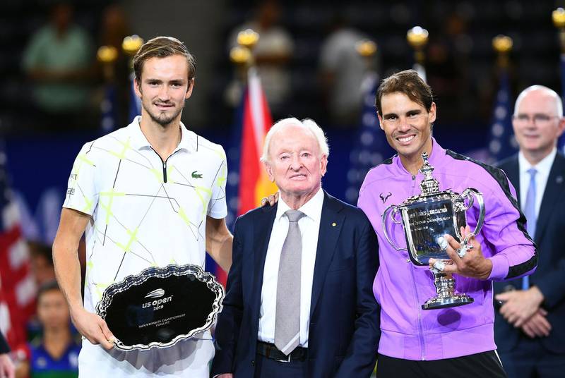 Rafael Nadal of Spain, right, holds the US Open trophy, next to Australian tennis great Rod Laver, centre, after his win over Daniil Medvedev. AFP