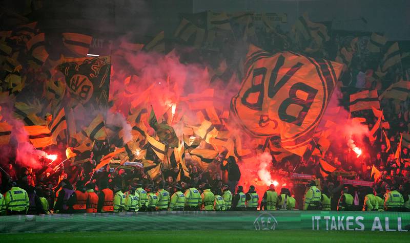 Borussia Dortmund fans set off flares before the Uefa Europa League play-off second leg match at Ibrox Stadium, Glasgow. PA