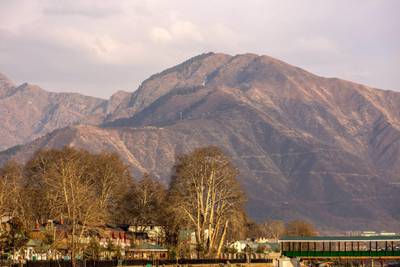 SRINAGAR, KASHMIR, INDIA - FEBRUARY 7: A view of mountains which used to be snow covered, during a warm winter day on February 7, 2018 in Srinagar, the summer capital of Indian administered Kashmir, India.The harshest 40-day period (Chilay Kalan) of the winter is almost over in Kashmir but the valley is yet to receive the season's first snowfall. Winter temperatures have increased in Kashmir and there is less snow now. Biologists believe that climate change is affecting living things worldwide, and the latest evidence suggests that warmer winters and long dry spells have decreased the water flow in rivers and streams, as there is no or less snow on the mountains.  The minimum temperatures have increased and this increase is not allowing rain to fall as snow, this has caused concern amongst those associated with agriculture and the fruit industry as the experts predict the unusual weather will impact the crop this year. (Photo by Yawar Nazir/Getty Images)