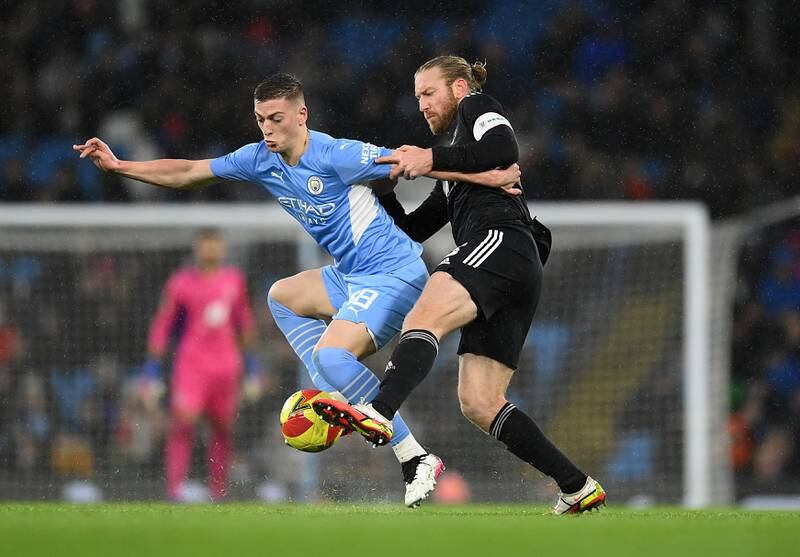 Tim Ream of Fulham tackles Liam Delap of Manchester City in an Emirates FA Cup Fourth-Round match at the Etihad Stadium in February, 2022. Getty
