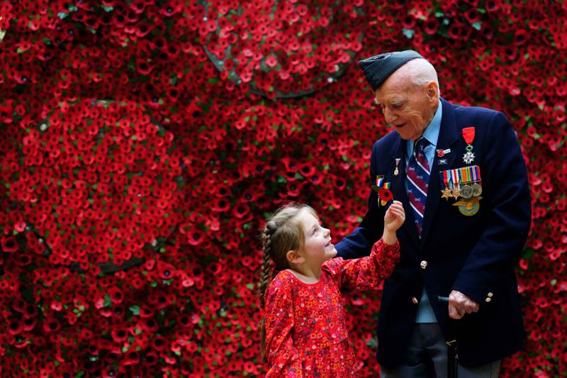 On Thursday, D-Day Veteran Bernard Morgan, 98, whose story is among those featured on the giant poppy wall, was given a poppy by Maya Renard, 6, during the launch of The Royal British Legion 2022 Poppy Appeal in London. PA