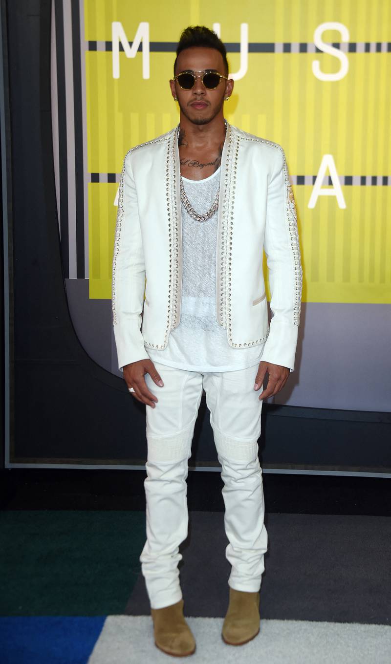 Lewis Hamilton, in white jeans and a jacket, arrives at the MTV Video Music Awards at the Microsoft Theatre in Los Angeles, California, on August 30, 2015. AFP